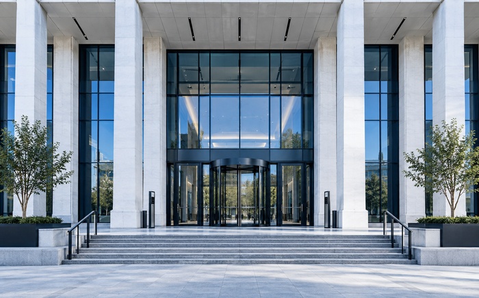 Entrance of a public building with columns and a revolving door